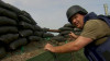 THAI MILITARY DETAIN JOURNALIST AND CHARGE HIM FOR CARRYING BODY ARMOUR.