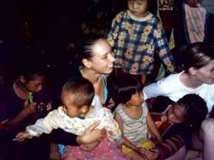 Holiday snaps from Vannessa Arscott and Adam Lloyd, taken just before they were murdered in Kanchanaburi by Thai police officer Somchai Wisetsingh. Vannessa surrounded by hill-tribe children, Northern Thailand.