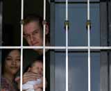David Scott, 35, from Swindon with his partner Cynthia, 29 Delfino and their 1 month old daughter Janina at a hideout on the outskirts of the Philippine capital Manila. The couple have been charged with adultery under Philippine law where divorce is illegal because Cynthia is married to a Filipino man.