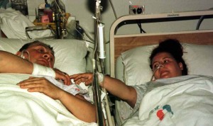 Geoffrey Taylor comforts his daughter Helen in the intensive care unit of the Bangkok Pattaya hospital in Pattaya. Helen's sister Andrea died when all 3 were mauled by an elephant at a show at the Nong Nooch Tropical Gardens near Pattaya, Thailand.